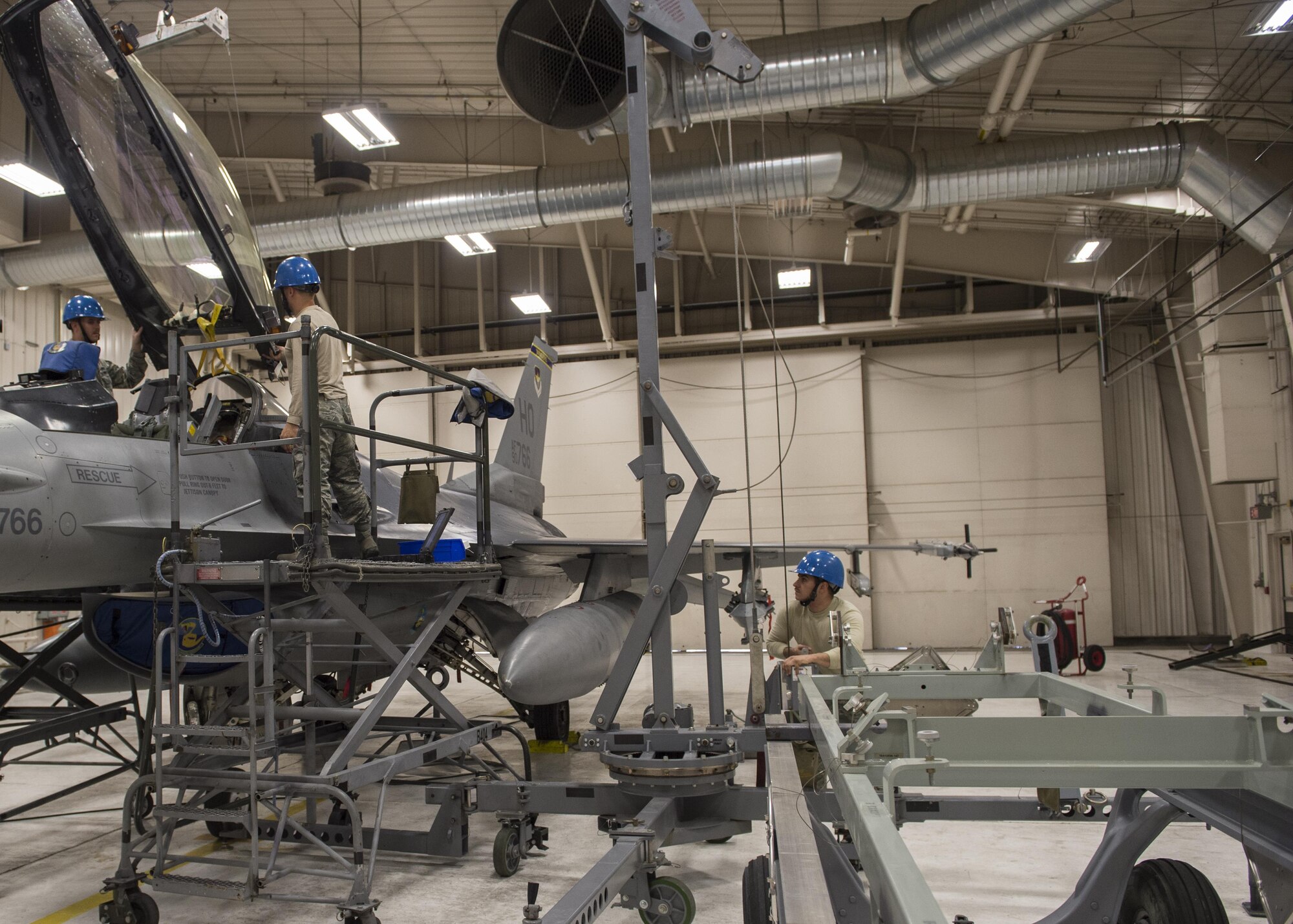 54th Maintenance Squadron egress system specialists remove a canopy from an F-16 Fighting Falcon on March 13, 2017 at Holloman Air Force Base, N.M. Egress system specialists ensure that pilots can safely eject from aircraft in the event of an emergency. They perform scheduled and unscheduled maintenance on seats, hatches, canopies and modules. (U.S. Air Force photo by Senior Airman Emily Kenney)