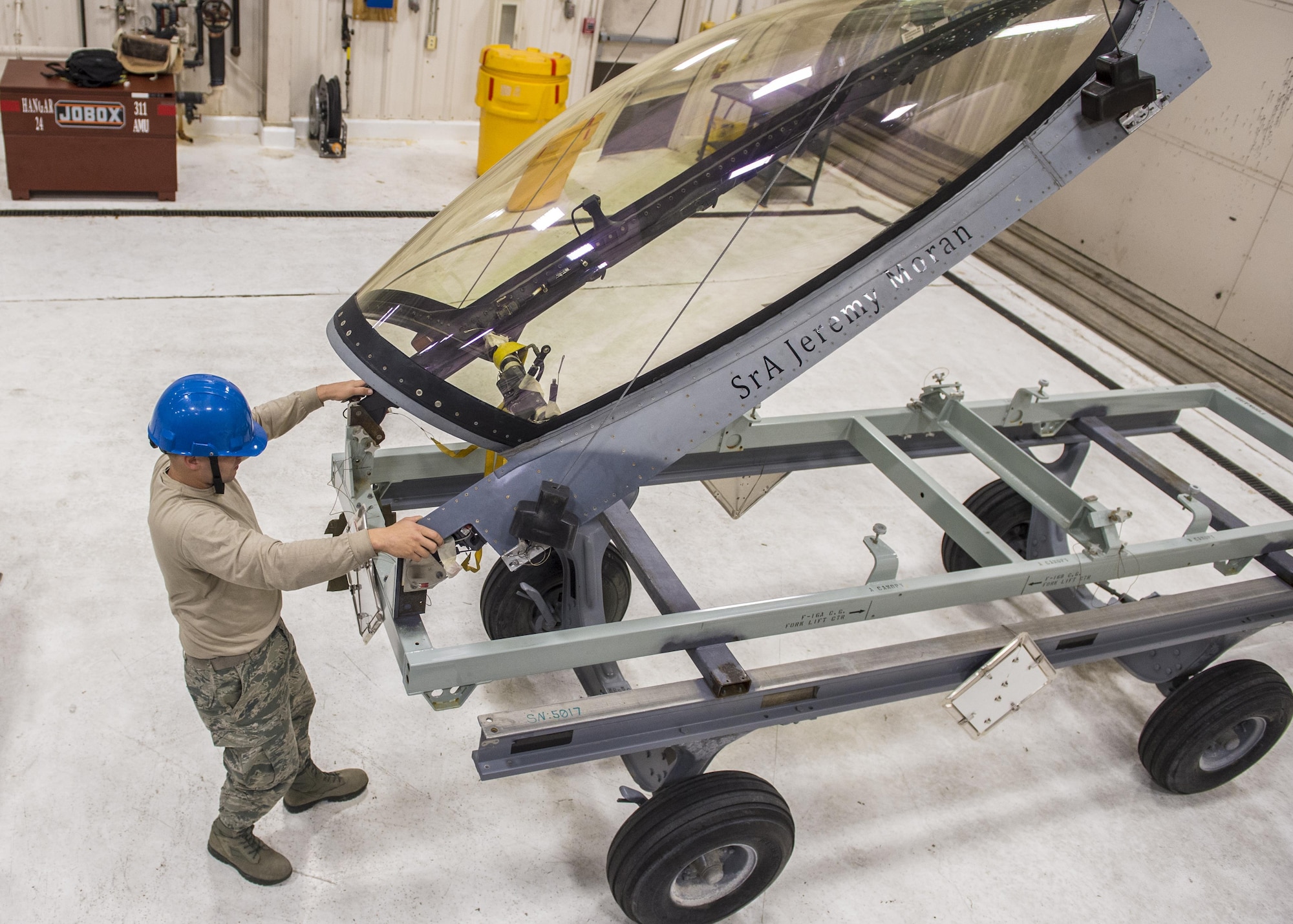 Staff Sgt. Mitchell Lawhorn, a 54th Maintenance Squadron egress systems craftsman, removes the canopy of an F-16 Fighting Falcon on March 13, 2017 at Holloman Air Force Base, N.M. Egress specialists work hand-in-hand with Aircrew Flight Equipment to ensure pilots have the necessary equipment in case of an emergency. (U.S. Air Force photo by Senior Airman Emily Kenney)