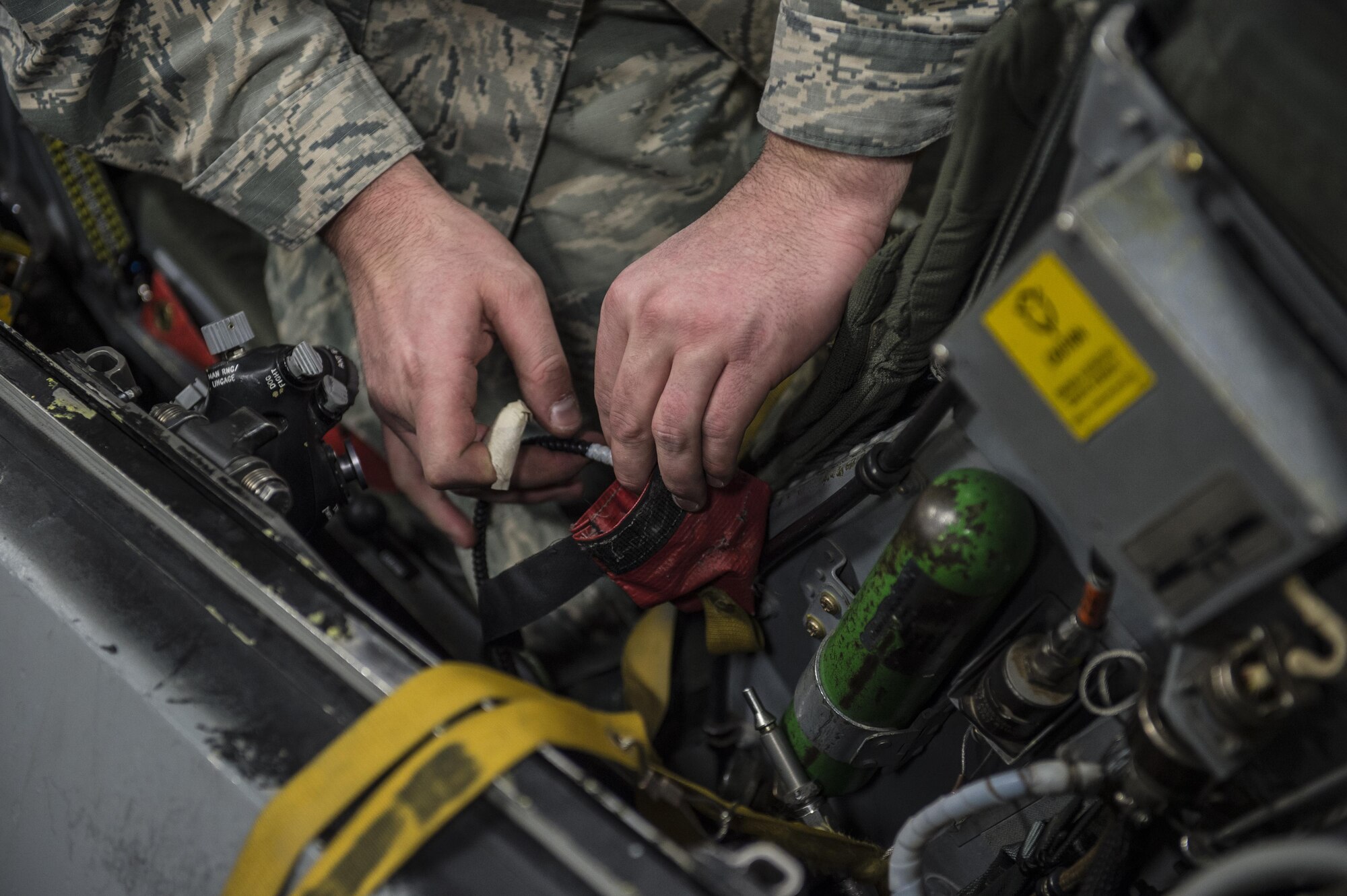 Tech. Sgt. Kevin Mayo, the 54th Maintenance Squadron egress section assistant Non-Commissioned Officer in Charge, removes wiring from an F-16 Fighting Falcon ejection seat on March 13, 2017 at Holloman Air Force Base, N.M. Egress specialists work hand-in-hand with Aircrew Flight Equipment to ensure pilots have the necessary equipment in case of an emergency. (U.S. Air Force photo by Senior Airman Emily Kenney)