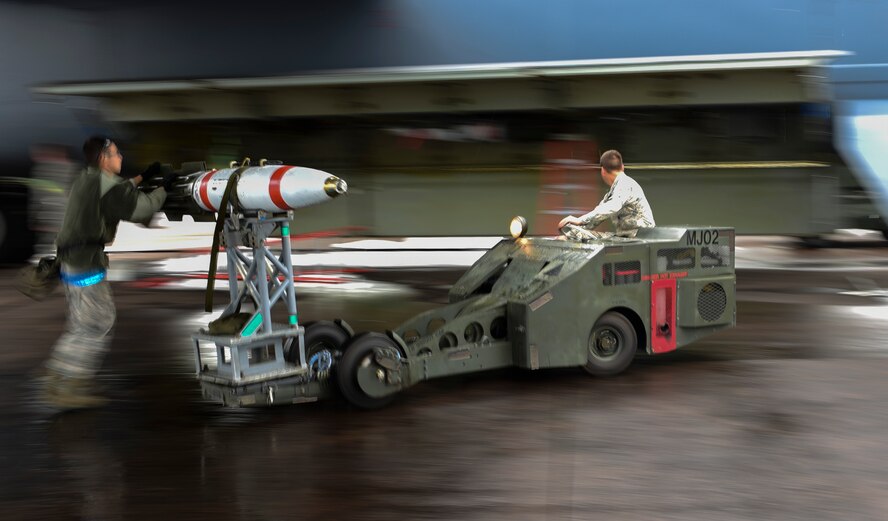 U.S. Air Force Senior Airman Michael Ruiz, left, and Airman 1st Class Nathaniel Martin, 2nd Aircraft Maintenance Squadron weapons load crew members, transport an inert, (non-explosive) Quick Strike MK 62 mine into the bomb bay of a B-52H Stratofortress at RAF Fairford, U.K., June 5, 2017. Bomber crews are participating in BALTOPS 2017, an annual, multinational, maritime-focused exercise designed to strengthen interoperability and cohesiveness between NATO allies and partnered nations. (U.S. Air Force photo by Airman 1st Class Randahl J. Jenson)  