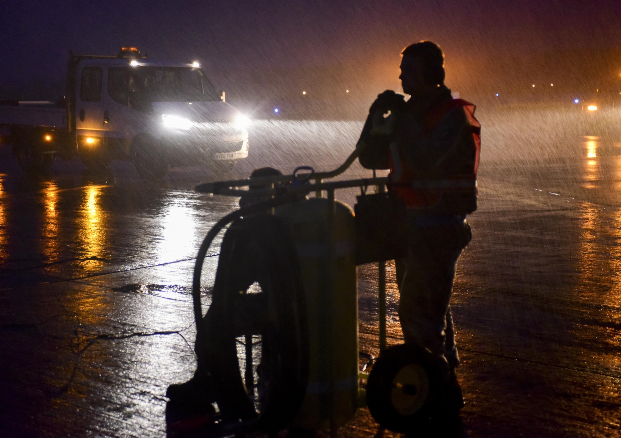 U.S. Air Force Senior Airmen Blake Nickells, 2nd Aircraft Maintenance Squadron assistant dedicated crew chief, waits out a storm while conducting pre-flight inspections on a B-52H Stratofortress at RAF Fairford, U.K., June 6, 2017. Exercises such as BALTOPS enable bomber crews to maintain a high state of readiness and proficiency and validate the bomber’s always-ready global strike capability. (U.S. Air Force photo by Airman 1st Class Randahl J. Jenson)  