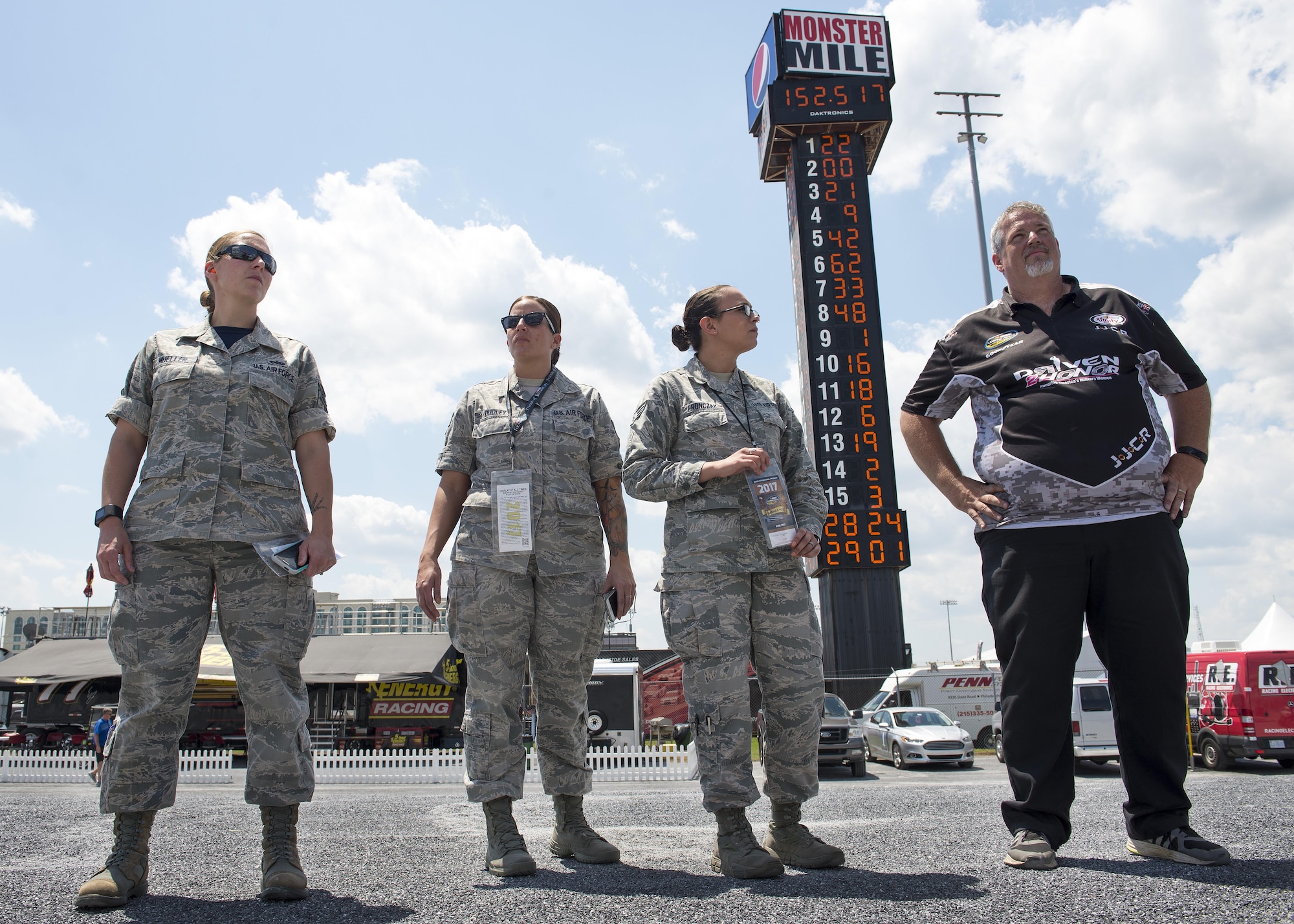 Tim Sliva, NASCAR Camping World Truck Series #10 Driven2Honor Chevrolet pit crew member, gives Team Dover Airmen a tour of pit road prior to the start of the Bar Harbor 200 June 2, 2017, at Dover International Speedway, Del. The Airmen were sponsored by the Driven2Honor organization. (U.S. Air Force photo by Senior Airman Zachary Cacicia)