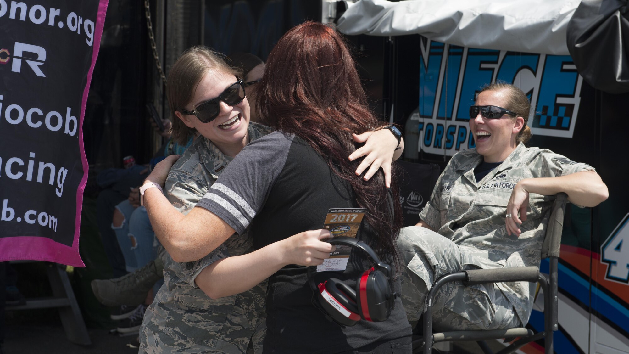 Jennifer Jo Cobb, NASCAR Camping World Truck Series #10 Driven2Honor Chevrolet driver, hugs 2nd Lt. Katherine Vaughn, 436th Airlift Wing Public Affairs officer, prior to the start of the Bar Harbor 200 June 2, 2017, at Dover International Speedway, Del. Vaughn was one female Airman hosted by Cobb’s Driven2Honor organization. (U.S. Air Force photo by Senior Airman Zachary Cacicia)
