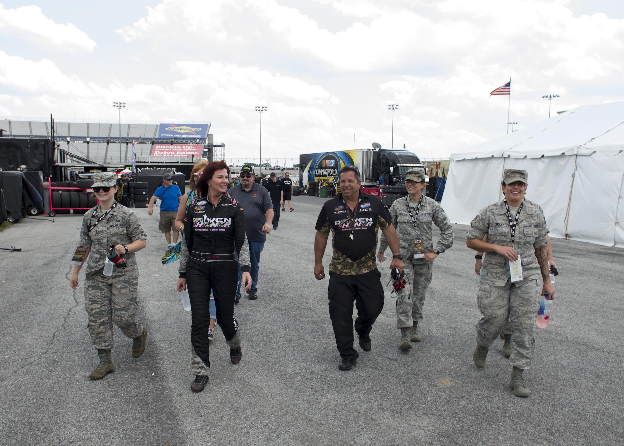 Jennifer Jo Cobb, NASCAR Camping World Truck Series #10 Driven2Honor Chevrolet driver, her pit crew, and Team Dover Airmen walk to pit road prior to the start of the Bar Harbor 200 June 2, 2017, at Dover International Speedway, Del. Cobb, through her not-for-profit organization Driven2Honor, hosted several female Airmen at the track. (U.S. Air Force photo by Senior Airman Zachary Cacicia)