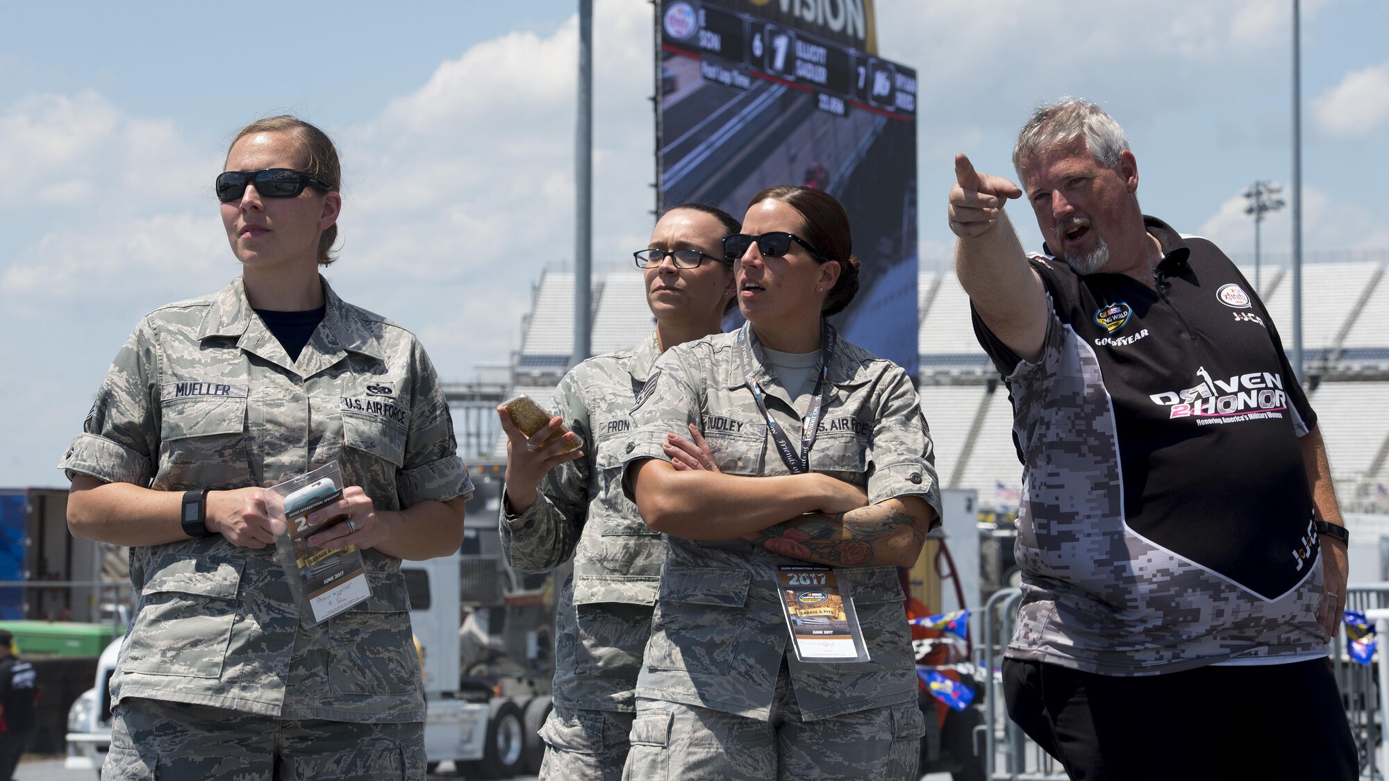 Tim Sliva, NASCAR Camping World Truck Series #10 Driven2Honor Chevrolet pit crew member, gives Team Dover Airmen a tour of pit road prior to the start of the “Bar Harbor 200” June 2, 2017, at Dover International Speedway, Del. Over the past six years, Driven2Honor has honored hundreds of military members at NASCAR races across the country. (U.S. Air Force photo by Senior Airman Zachary Cacicia)