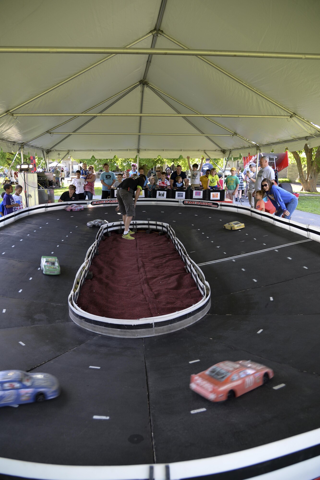 Remote control racecars operated by Team Dover members speed around a miniature track during the biannual NASCAR Social June 2, 2017, at Dover Air Force Base, Del. Before every race weekend at Dover International Speedway, Team Dover members celebrate at the free kickoff party on base. (U.S. Air Force photo by Senior Airman Aaron J. Jenne)