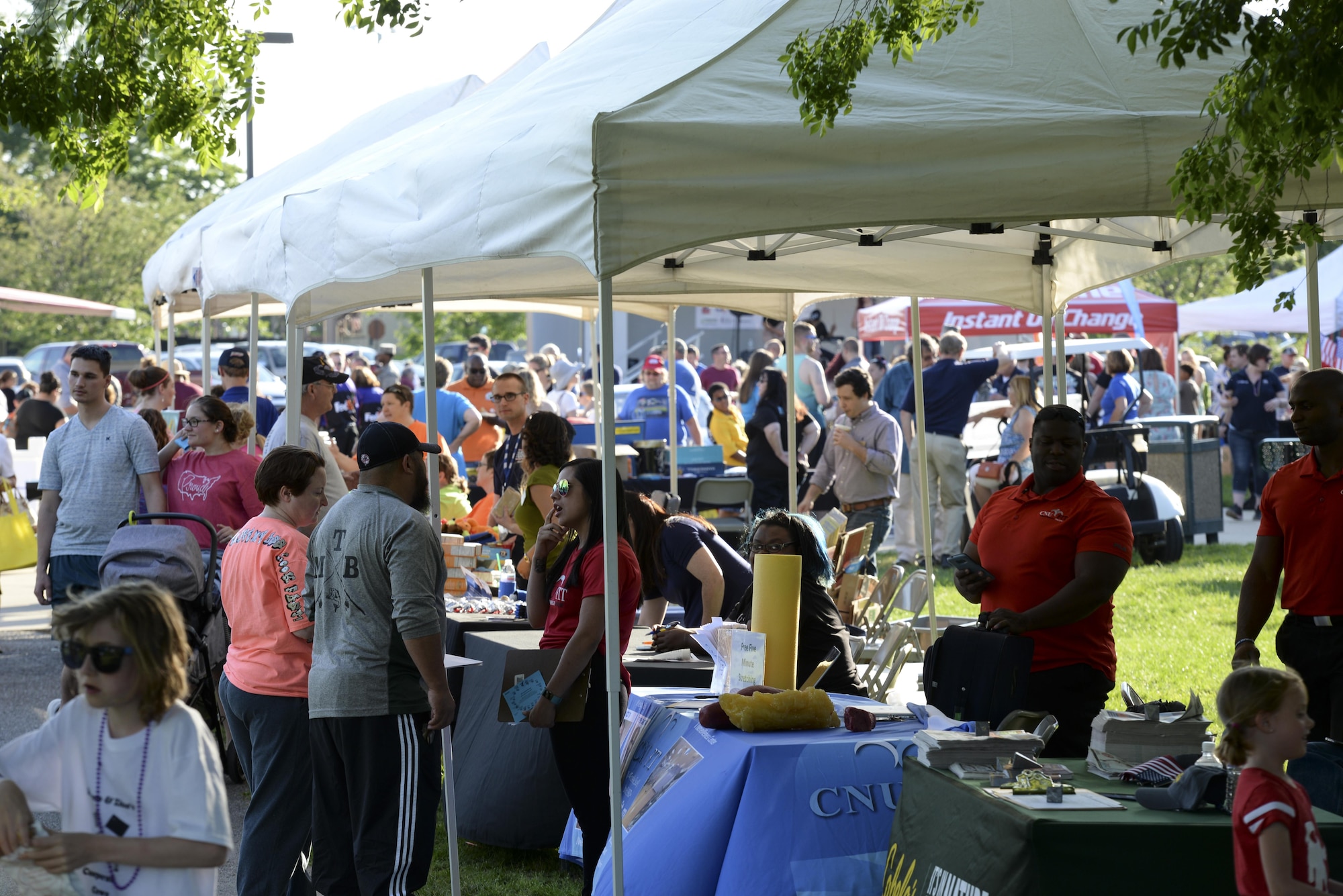 Representatives from supporting base and community agencies speak with members of Team Dover during the biannual NASCAR Social June 2, 2017, at Dover Air Force Base, Del. More than 20 tables with information and free items were set up at the event. (U.S. Air Force photo by Senior Airman Aaron J. Jenne)