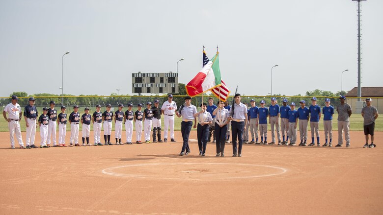 The Aviano Tigerz and Junior Alpina baseball teams line up for the American and Italian National Anthems prior to their baseball game June 3, 2017, at Aviano Air Base, Italy. The Aviano Tigerz hosted the Junior Alpina team from Trieste, Italy, in a friendly match that fostered competition and friendship. (U.S. Air Force photo by Senior Airman Cory W. Bush)