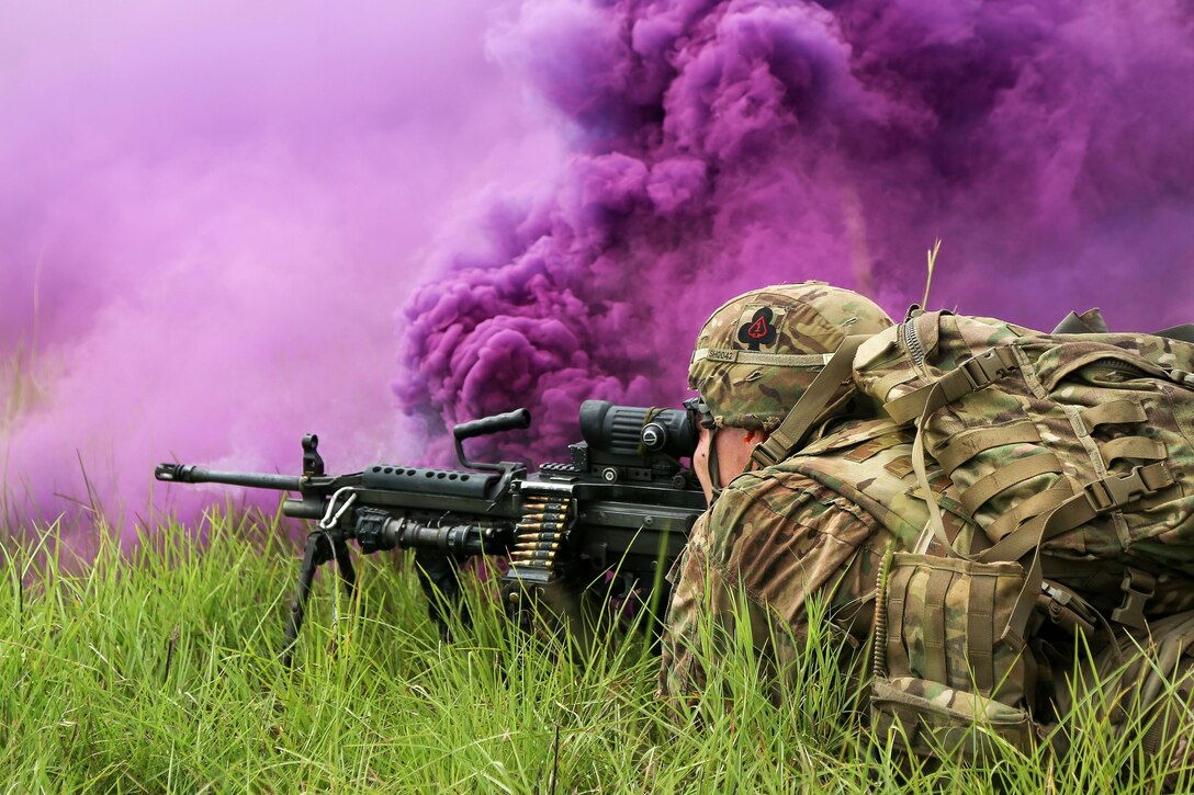 A soldier participates in a live-fire training event amid purple smoke as part of Exercise United Accord 2017 at Bundase Training Camp in Bundase, Ghana, May 27, 2017. The soldier is assigned to the 1st Battalion, 506th Infantry Regiment. Army photo by Pfc. Joseph Friend