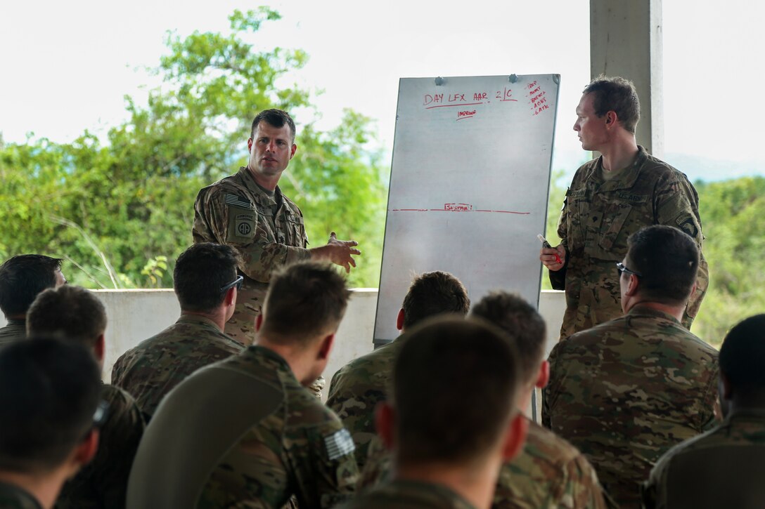 Army Lt. Col. Eugene Ferris, left, commander of the 101st Airborne Infantry Division’s 1st Battalion, 506th Infantry Regiment, 1st Brigade Combat Team conducts an after action review with soldiers who conducted a live-fire training event during Exercise United Accord 2017 at Bundase Training Camp in Bundase, Ghana, May 27, 2017. Army photo by Pfc. Joseph Friend