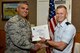 U.S. Air Force Col. Alex Ganster, 17th Training Group Commander, presents the 315th Training Squadron Officer Student of the Month award for May 2017 to 2nd Lt. Michael Bremer, 315th TRS student, in Brandenburg Hall on Goodfellow Air Force Base, Texas, June 2, 2017. (U.S. Air Force photo by Staff Sgt. Joshua Edwards/Released)