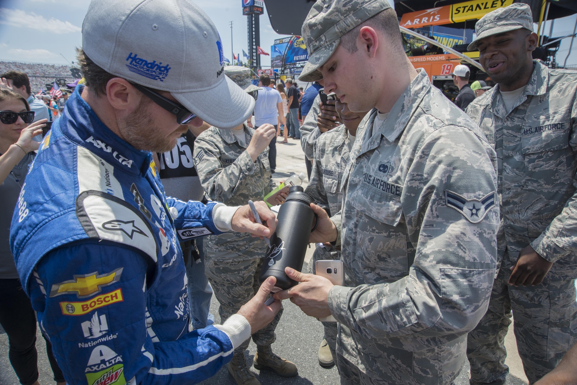 Dale Earnhardt Jr., driver of the No. 88 Nationwide Insurance Chevrolet, signs Airman 1st Class Dylan Greene’s, 436th Maintenance Squadron crew chief, water bottle before the start of the AAA 400 Drive for Autism Monster Energy race June 4, 2017, at Dover International Speedway, Dover, Del. Greene was an honorary pit crew member and was able to experience NASCAR from the pits. (U.S. Air Force photo by Staff Sgt. Jared Duhon)