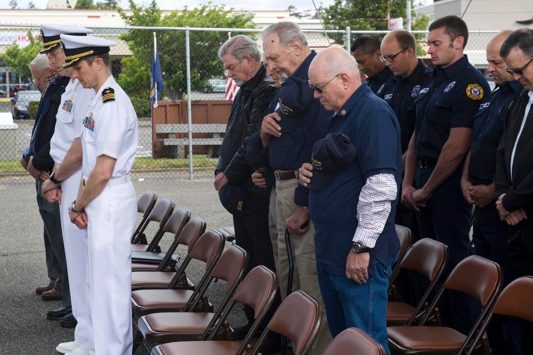 Service members, veterans and civilians observe a moment of silence during a Battle of Midway commemoration ceremony at the PBY-Naval Air Museum in Oak Harbor, Wash., June 2, 2017. The ceremony commemorated the 75th anniversary of the momentous World War II naval battle, and honored those who served and died in the war. Navy photo by Petty Officer 2nd Class Scott Wood