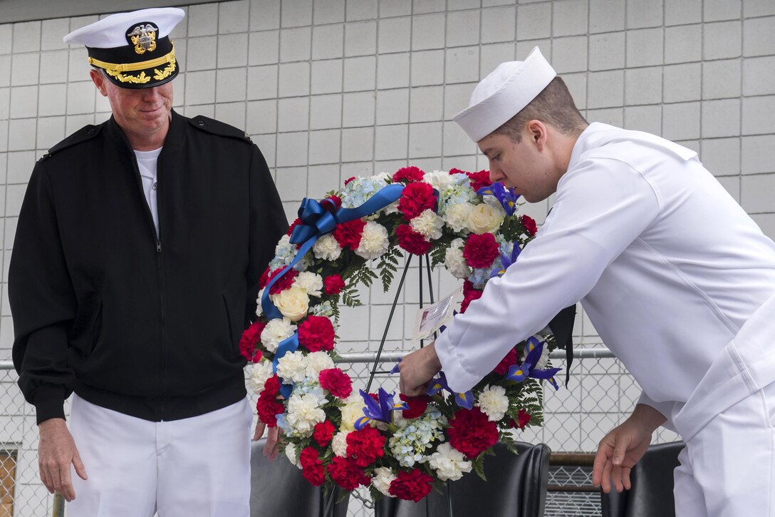 Navy Capt. Geoffrey Moore, left, commander of Naval Air Station Whidbey Island, and Petty Officer 3rd Class Killian Ferrel place a ceremonial wreath during a ceremony commemorating the 75th anniversary of the Battle of Midway at the PBY-Naval Air Museum in Oak Harbor, Wash., June 2, 2017. Navy photo by Petty Officer 2nd Class Scott Wood