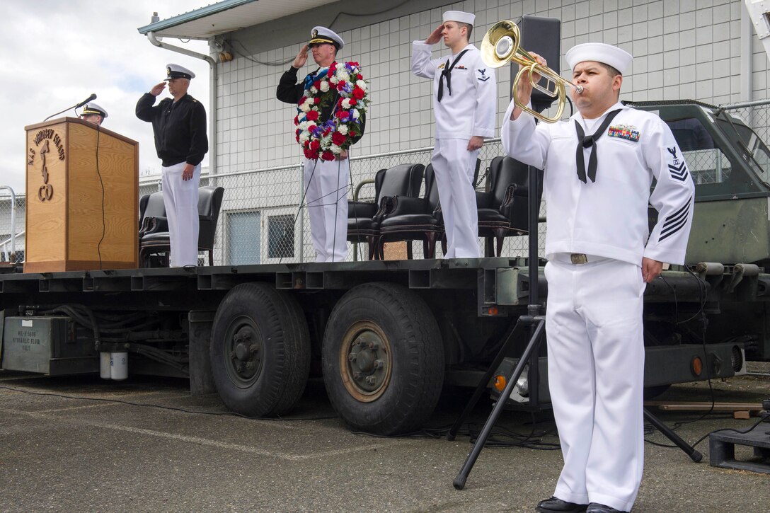 Navy Petty Officer 1st Class John Contreras plays taps during a ceremony commemorating the 75th anniversary of the Battle of Midway at the PBY-Naval Air Museum in Oak Harbor, Wash., June 2, 2017. Contreras is a culinary specialist assigned to Naval Air Station Whidbey Island. Navy photo by Petty Officer 2nd Class Scott Wood 