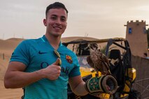 United Arab Emirates (March 19, 2017) U.S. Marine Cpl. Jesus Oliveros, a legal clerk with the 11th Marine Expeditionary Unit (MEU), poses for a picture while holding a falcon as part of a Sunset Safari tour during the 11th MEU’s port visit to United Arab Emirates, March 19. Port calls are a unique experience for Marines because they provide an opportunity for Marines to immerse themselves with a different culture while on deployment. The Makin Island Amphibious Ready Group/11th MEU is currently deployed to the U.S. 5th Fleet area of operations in support of regional security and stability. (U.S. Marine Corps by Lance Cpl. Brandon Maldonado)