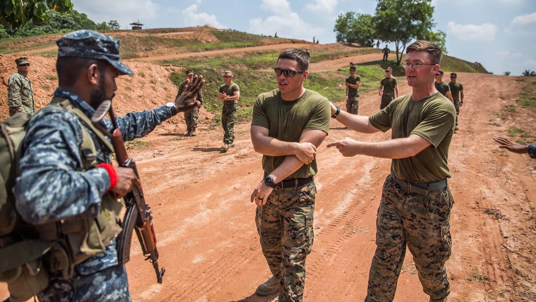 WELISARA NAVAL BASE, Sri Lanka (March 30, 2017) U.S. Marines with Combat Logistics Battalion 11, 11th Marine Expeditionary Unit, acting as simulated disaster victims, approach the entry control point of a humanitarian assistance and disaster relief (HA/DR) camp during HA/DR training at Welisara Naval Base as part of a theater security cooperation engagement, March 30. Working with foreign militaries provides U.S. Marines and Sailors valuable training with warriors from another culture and builds camaraderie between partner nations’ militaries. (U.S. Marine Corps photo by Cpl. Devan K. Gowans)