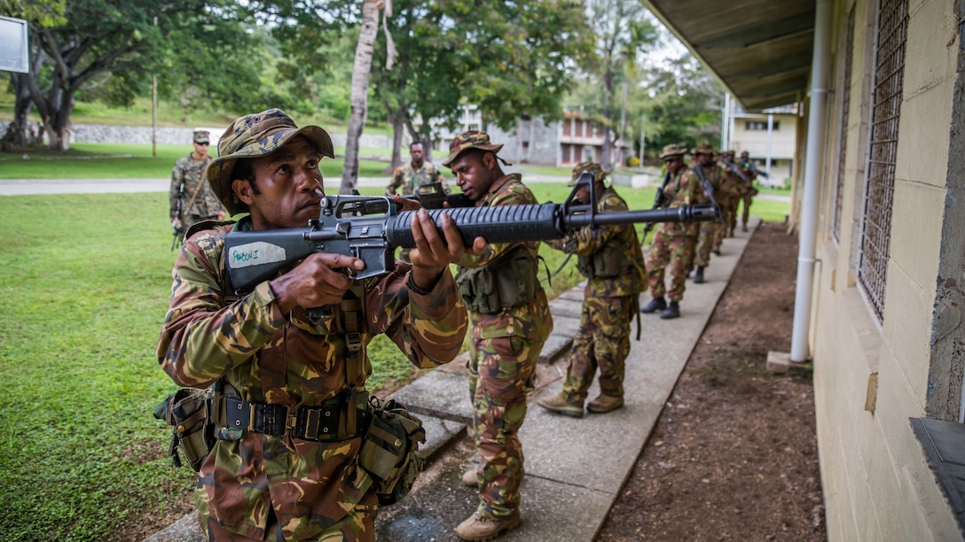 TAURAMA, Papua New Guinea (April 17, 2017) Papua New Guinea Defense Force (PNGDF) service members provide perimeter security while moving past a building during a military tactics exchange conducted alongside U.S. Marines with the 11th Marine Expeditionary Unit at Taurama Barracks as part of a theater security cooperation engagement, April 17. Marines and Sailors embarked aboard USS Comstock (LSD 45) are in Papua New Guinea, focused on increasing military ties with the PNGDF and preparedness for military support to civil authority roles. (U.S. Marine Corps photo by Cpl. Devan K. Gowans)