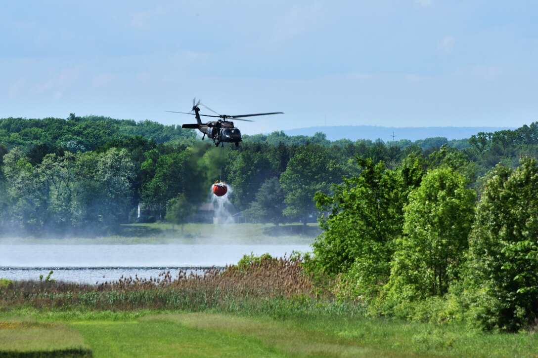 New York Army National Guard fill a bucket firefighting system during training near Round Lake, N.Y., May 31, 2017. Army National Guard photo by Pfc. Andrew Valenza