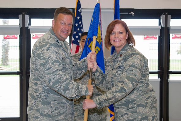 Col. Matthew Wallace, 45th Mission Support Group commander, presents Maj. Dawn Baker, 45th Logistics Readiness Squadron commander, with a guidon during a change of command ceremony June 6, 2017, at Patrick Air Force Base, Fla. Changes of command are a military tradition representing the transfer of responsibilities from the presiding official to the upcoming official. 