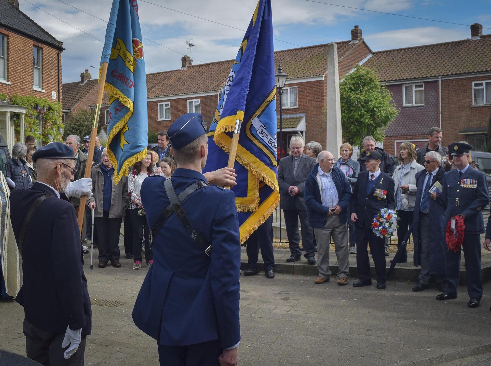 2nd Lt. Andrew Henderson, 36th Electronic Warfare Squadron EW engineer, holds the 36th Bombardment Squadron heritage flag during a wreath-laying ceremony at Foulsham Memorial on May 12, 2017. Henderson, along with four additional 36th EWS members, represented the unit at various memorials, dinners, luncheons, teas and wreath-laying ceremonies during the 20th Annual Royal Air Force 100 Group Association Reunion. (Courtesy Photo)
