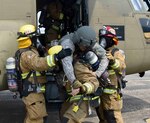 Firefighters rescue a pilot from CH-47 Chinook during the CH-47 Egress Training at the Camp Walker Heliport, May 31, 2017. Main missions for the firefighters are to mitigate hazards, rescue and triage the injured and take proper care of the patients.