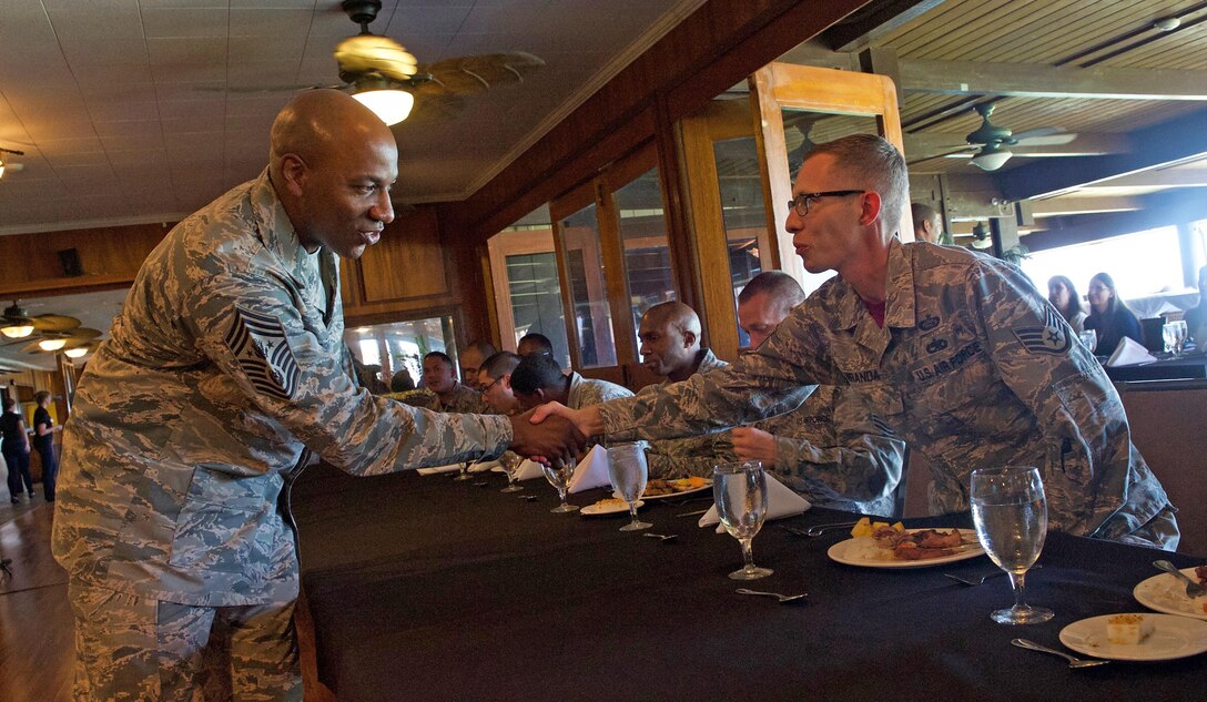 Chief Master Sgt. of the Air Force Kaleth O. Wright (left) greets Staff Sgt. Justin Miranda, Headquarters Pacific Air Forces training manager, during a luncheon at Joint Base Pearl Harbor-Hickam, Hawaii, June 2, 2017. Wright was accompanied by Chief Master Sgt. Anthony W. Johnson, PACAF command chief, and made several stops across the base, providing an opportunity for Airmen to interact with him and discuss their concerns. (U.S. Air Force photo/Tech. Sgt. Kamaile Chan)