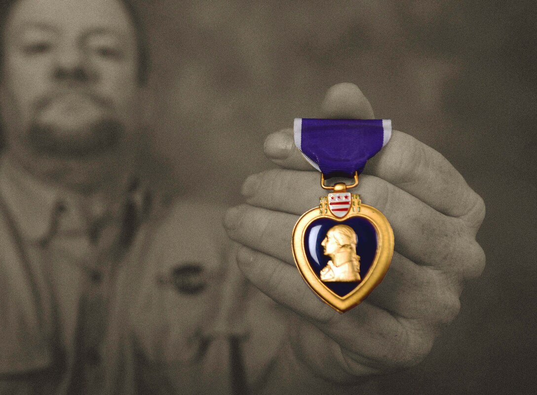 Gregory Carter, the Air Force Repair Enhancement Program manager assigned to the 28th Maintenance Group, diplays his Purple Heart at Ellsworth Air Force Base, S.D., June 1, 2017. Carter was awarded the Purple Heart in 1996. (U.S. Air Force photo illustration by Airman 1st Class Donald C. Knechtel)