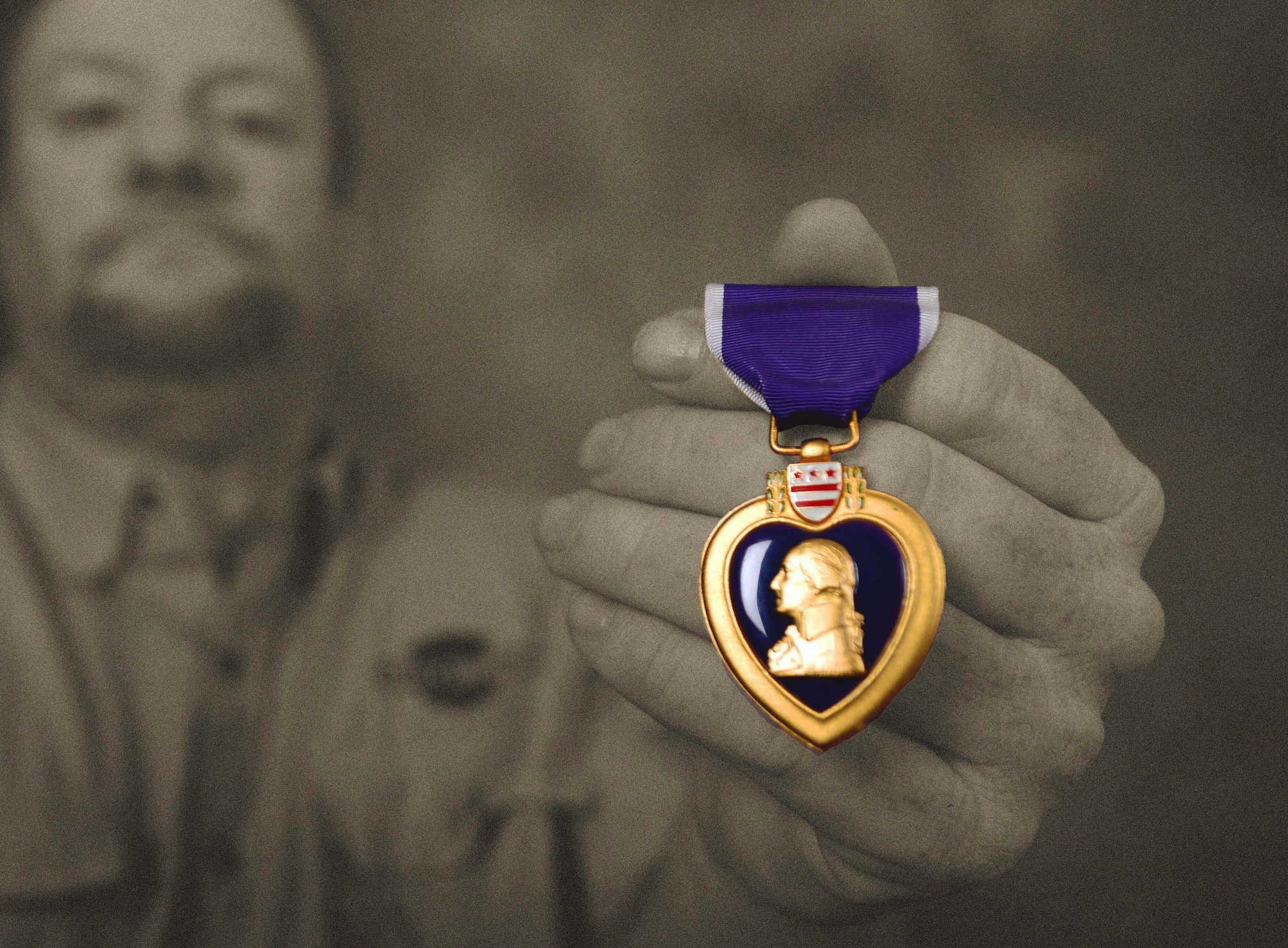 Gregory Carter, the Air Force Repair Enhancement Program manager assigned to the 28th Maintenance Group, diplays his Purple Heart at Ellsworth Air Force Base, S.D., June 1, 2017. Carter was awarded the Purple Heart in 1996. (U.S. Air Force photo illustration by Airman 1st Class Donald C. Knechtel)