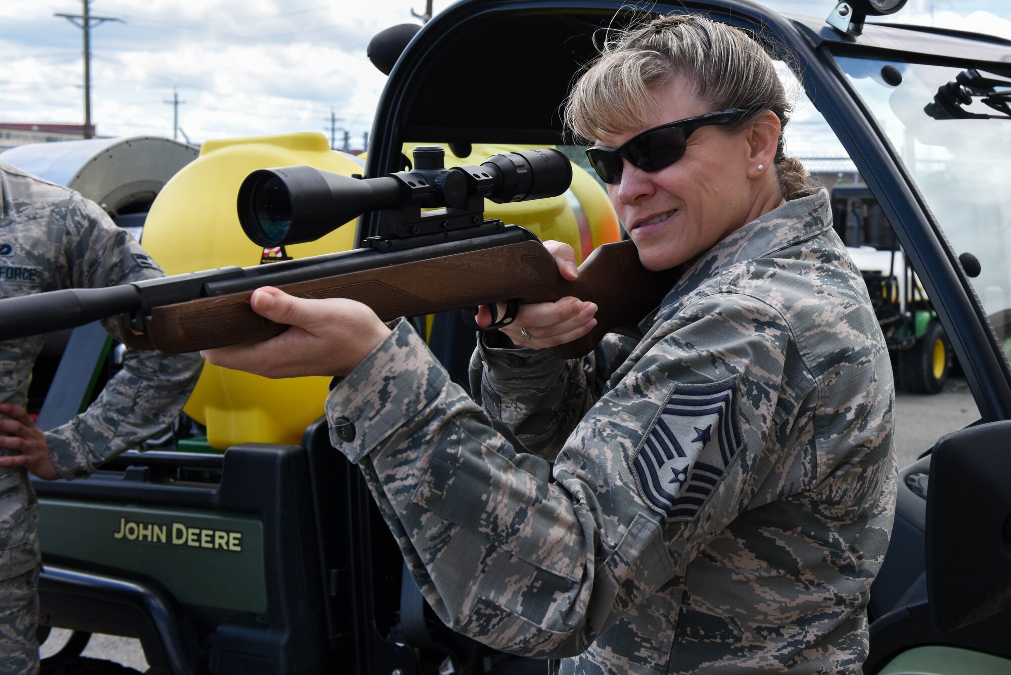 Chief Master Sgt. Theresa Clapper, 2nd Bomb Wing command chief, shoots a pellet rifle while visiting the 2nd Civil Engineer Squadron Pest Management office, May 24, 2017. Pest management uses riffles to help control the wildlife populations of animals such as raccoons or opossums on base. (U.S. Air Force photo/Airman 1st Class Sydney Bennett)