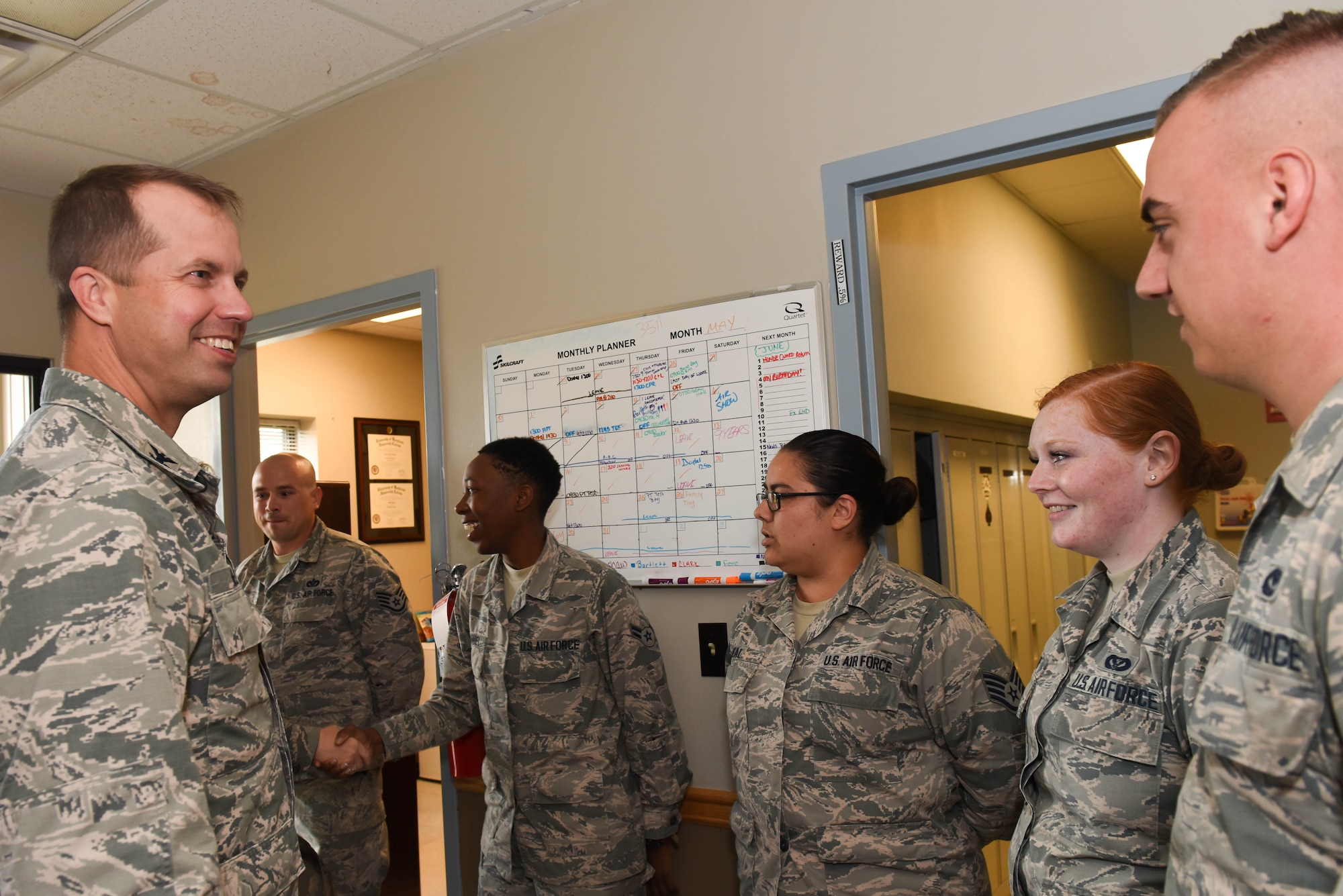 Col. Ty. Neuman, 2nd Bomb Wing commander, is greeted by the staff of the 2nd Civil Engineer Squadron Pest Management office on Barksdale Air Force Base, La., May 24, 2017. Pest management specializes in controlling and killing the population of rodents, insects, and other pests on base. (U.S. Air Force photo/Airman 1st Class Sydney Bennett)