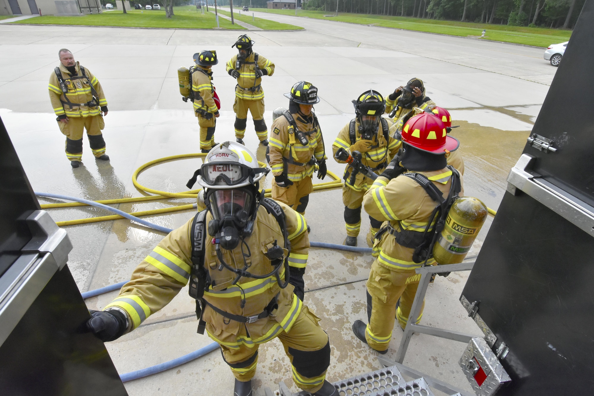 Arnold Air Force Base paramedic/firefighters prepare to enter the Kentucky Fire Commission mobile live fire rescue simulation training structure on May 11. Forty-one base firefighters, participated in the annual training experiencing high temperatures and smoke, and practicing firefighting and self-rescue techniques. (U.S. Air Force photo/Rick Goodfriend)