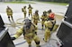 Arnold Air Force Base paramedic/firefighters prepare to enter the Kentucky Fire Commission mobile live fire rescue simulation training structure on May 11. Forty-one base firefighters, participated in the annual training experiencing high temperatures and smoke, and practicing firefighting and self-rescue techniques. (U.S. Air Force photo/Rick Goodfriend)