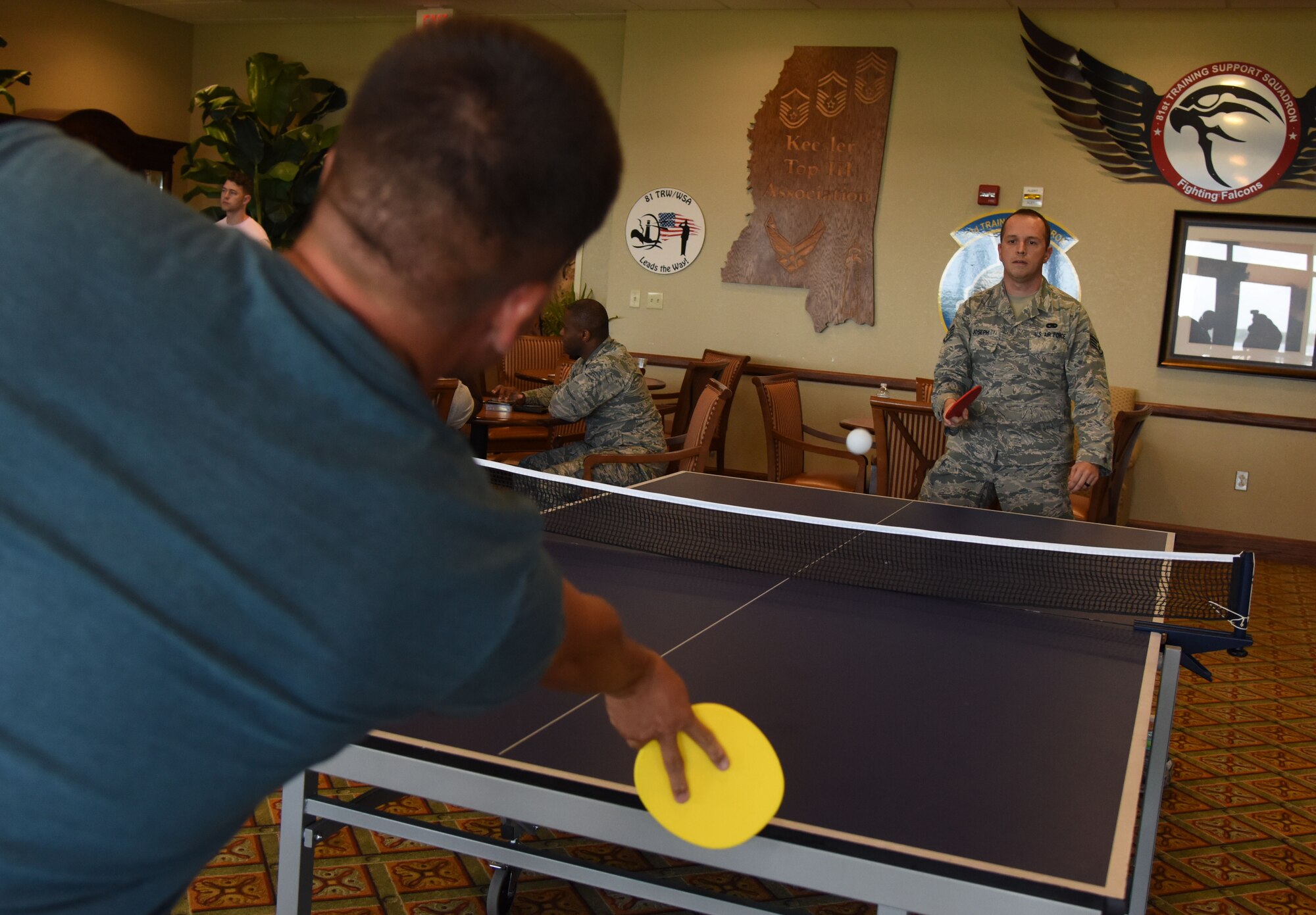 Staff Sgts. Cody Sanderson and Bryan Joseph, 81st Logistics Readiness Squadron vehicle maintainers, play a game of ping pong during the Keesler Summer Bash at the Bay Breeze Event Center June 1, 2017, on Keesler Air Force Base, Miss. The bash consisted of demonstrations by the 338th Training Squadron drill team and the 81st Security Forces Squadron military working dogs, games and free food. (U.S. Air Force photo by Kemberly Groue)