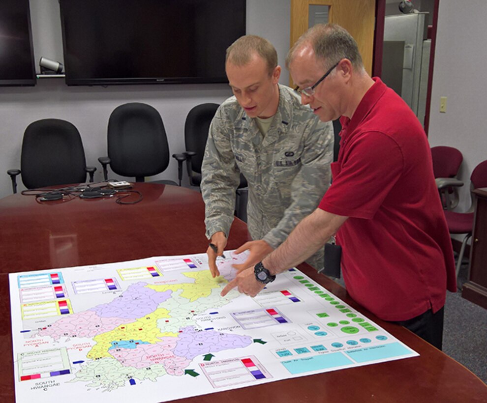 Defense Logistics Agency Operations Research and Resource Analysis' Air Force Capt. Raymond Hill, wargaming program manager operations research analyst and David Jones practice wargaming strategies for the Advancing Globally Integrated Logistics Effort 2017 humanitarrian assistance/disaster relief wargame event hosted by the Chairman of the Joint Chief of Staff, at Lockheed-Martin Center for Innovation in Suffolk, Virginia. May 17 - 25, 2017.