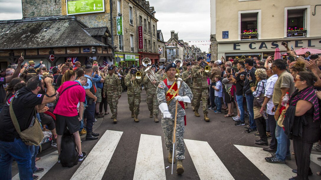The U.S. Army Europe Band, led by drum major Staff Sgt. Redentor Aledia, marches in a parade in Sainte-Mere-Eglise, France, June 4, 2017, to commemorate the 73rd anniversary of D-Day. Army photo by Spc. Joseph Agacinski