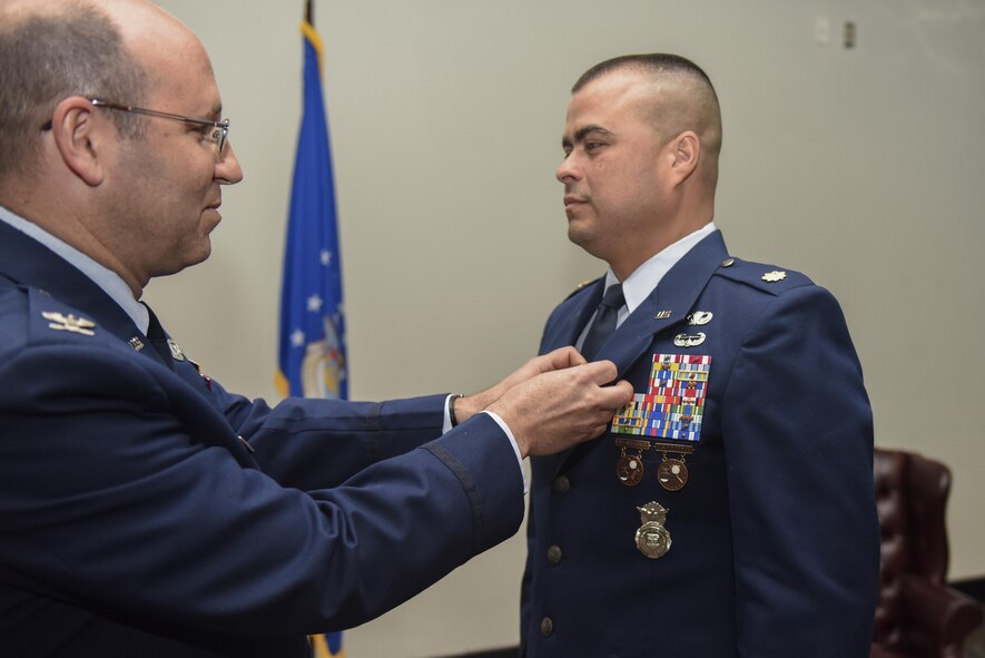 U.S. Air Force Maj. Pedro Jimenez, 17th Security Forces Squadron Commander, receives a Meritorious Service medal during the 17th SFS Change of Command ceremony at the Event Center on Goodfellow Air Force Base, Texas, June 5, 2017. Jimenez received the medal for outstanding service. (U.S. Air Force photo by Airman 1st Class Chase Sousa/Released)