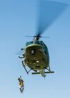 An Airman with the 5th Civil Engineer Squadron is hoisted by a UH-1N Iroquois at Minot Air Force Base, N.D., June 1, 2017. The unit held an Expeditionary Training Day to help prepare Airmen for future combat deployments. (U.S. Air Force photo/Airman 1st Class Jonathan McElderry)