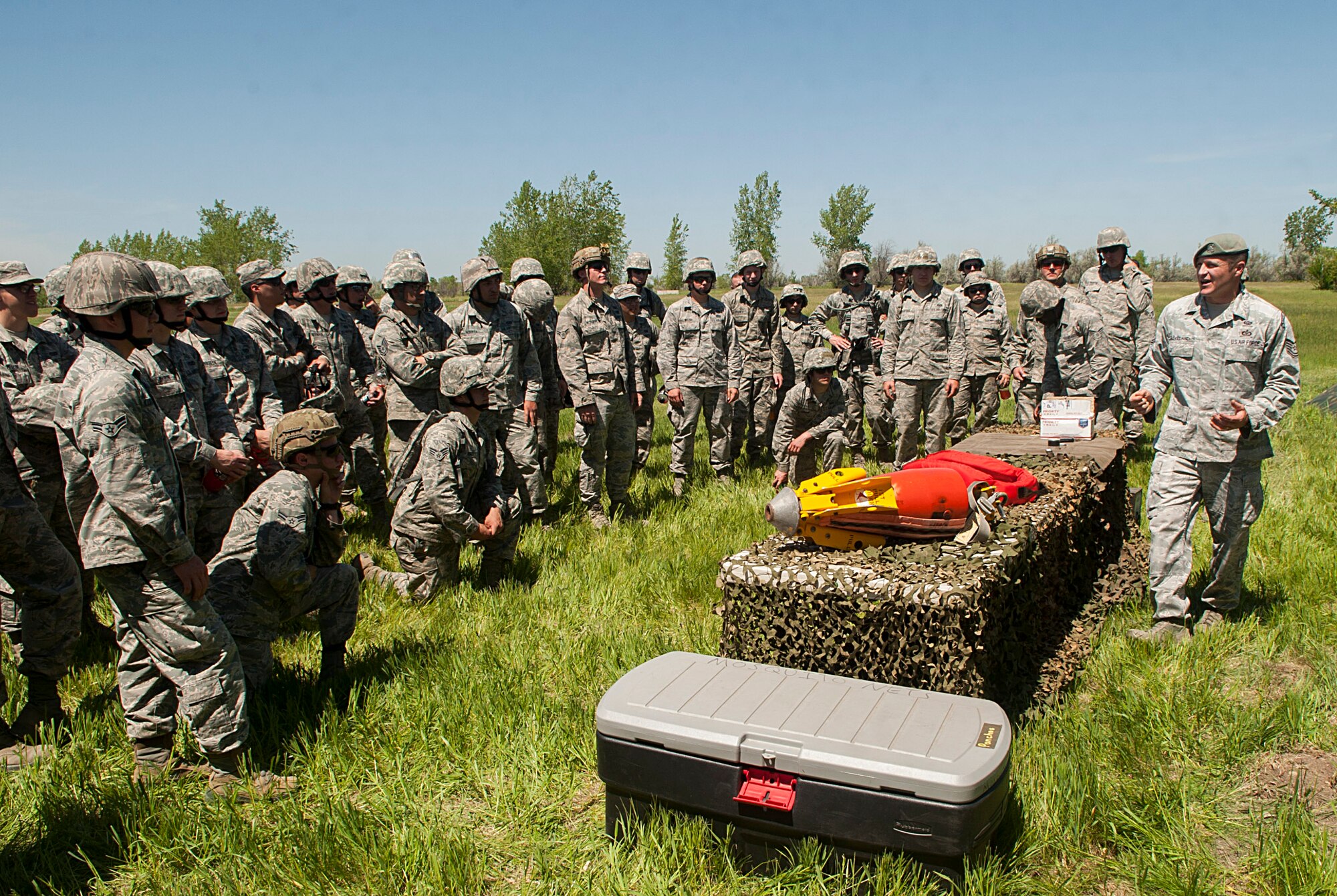 Tech. Sgt. Clifton Cleveland, 5th Operations Support Squadron survival, evasion, resistance and escape specialist, briefs 5th Civil Engineer Squadron Airmen at Minot Air Force Base, N.D., June 1, 2017. The CES Airmen learned how to set up tents in six minutes during their Expeditionary Training Day. (U.S. Air Force photo/Airman 1st Class Jonathan McElderry)