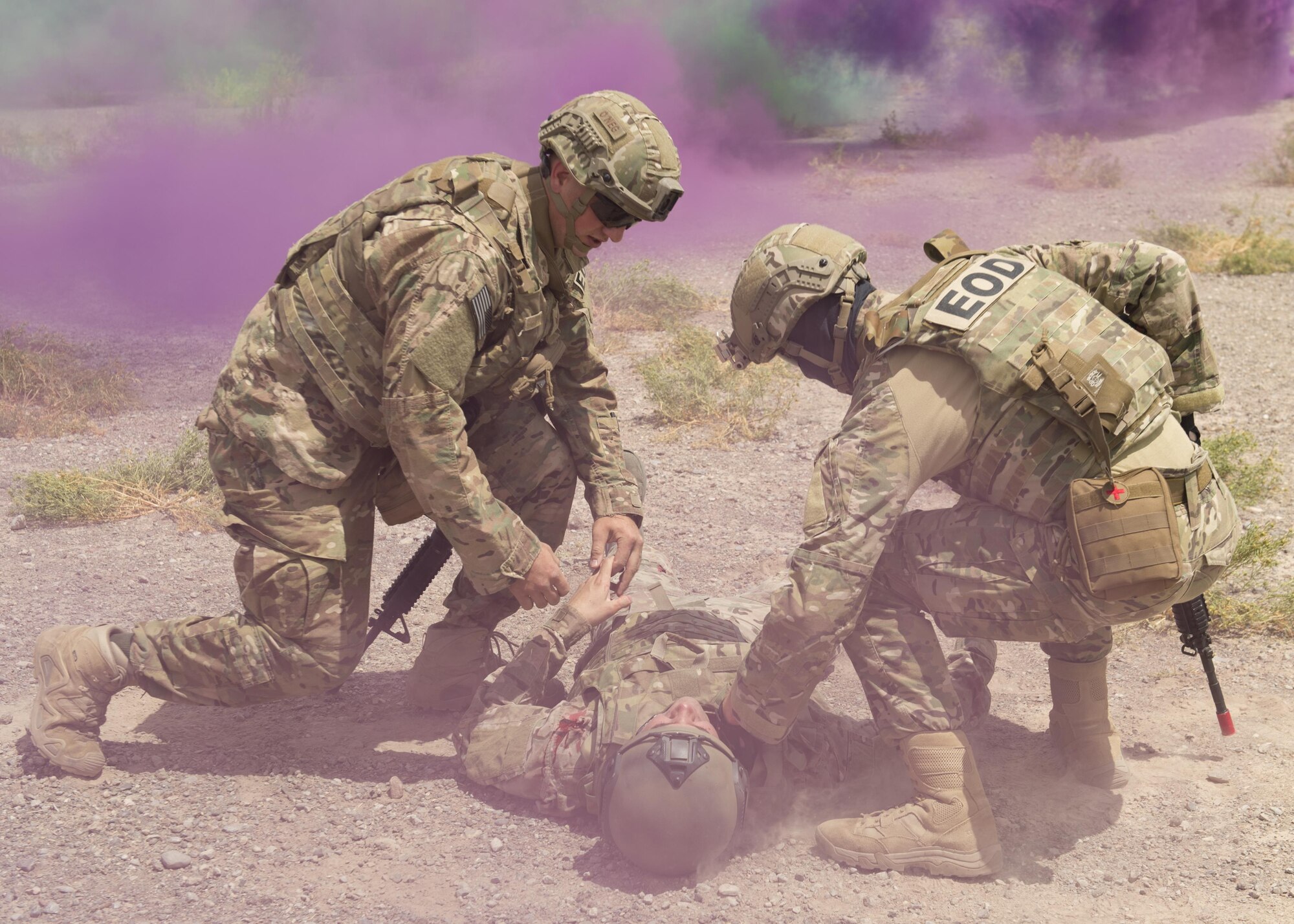 Explosive Ordnance Disposal Airmen check for life-signs on a simulated casualty during a Tactical Combat Casualty Care exercise at Holloman Air Force Base, N.M., on April 31, 2017. The training focuses on individual trauma, tools, techniques, and treatment procedures. The exercise also included the use of moulage, non-lethal training munitions, trained role-players, and a multitude of other artificial stressors. (U.S. Air Force Photo by Senior Airman Chase Cannon)