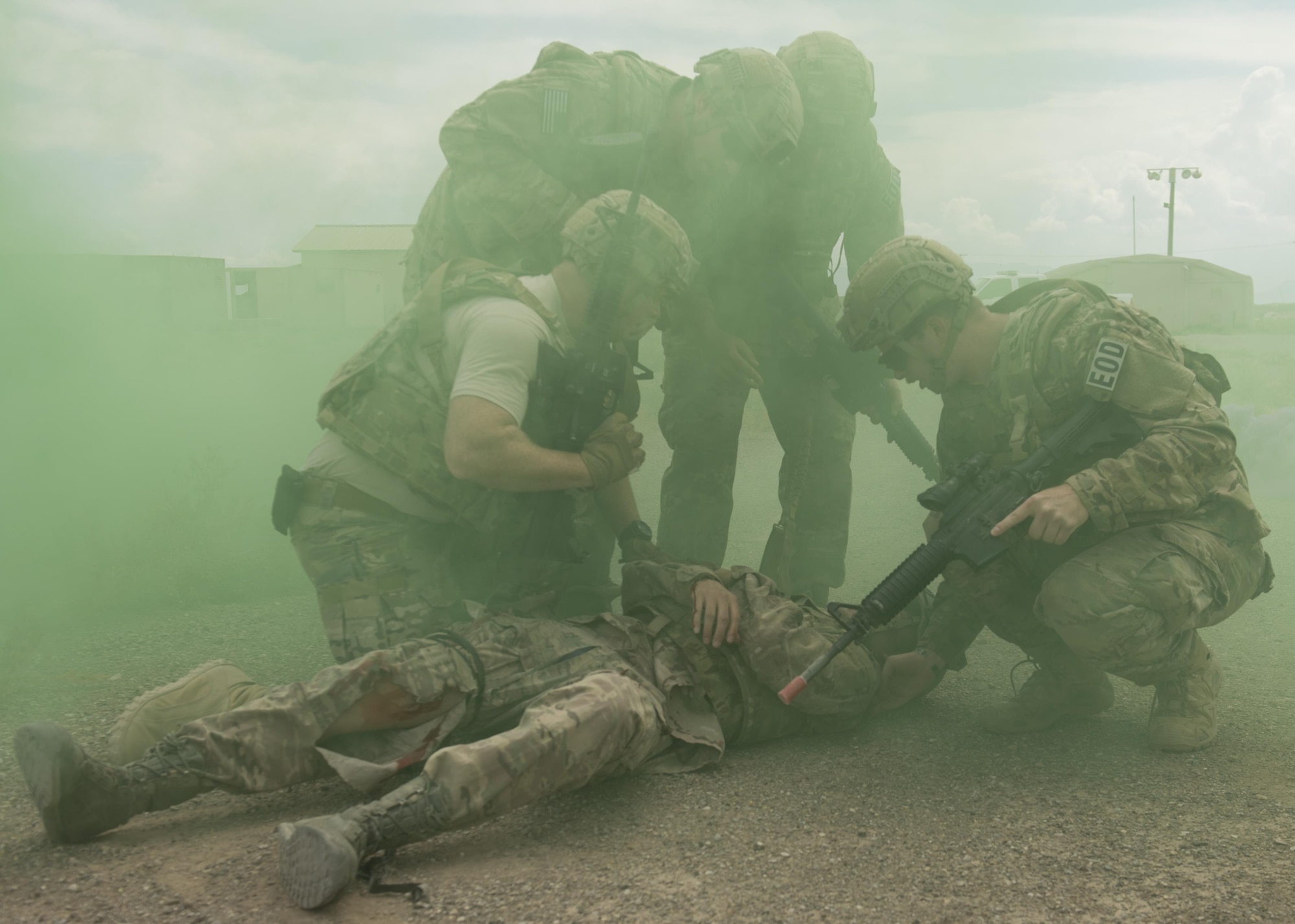 Explosive Ordnance Disposal Airmen assess a simulated casualty during a Tactical Combat Casualty Care exercise at Holloman Air Force Base, N.M., on April 31, 2017. The training focuses on individual trauma, tools, techniques, and treatment procedures. The exercise also included the use of moulage, non-lethal training munitions, trained role-players, and a multitude of other artificial stressors. (U.S. Air Force Photo by Senior Airman Chase Cannon)