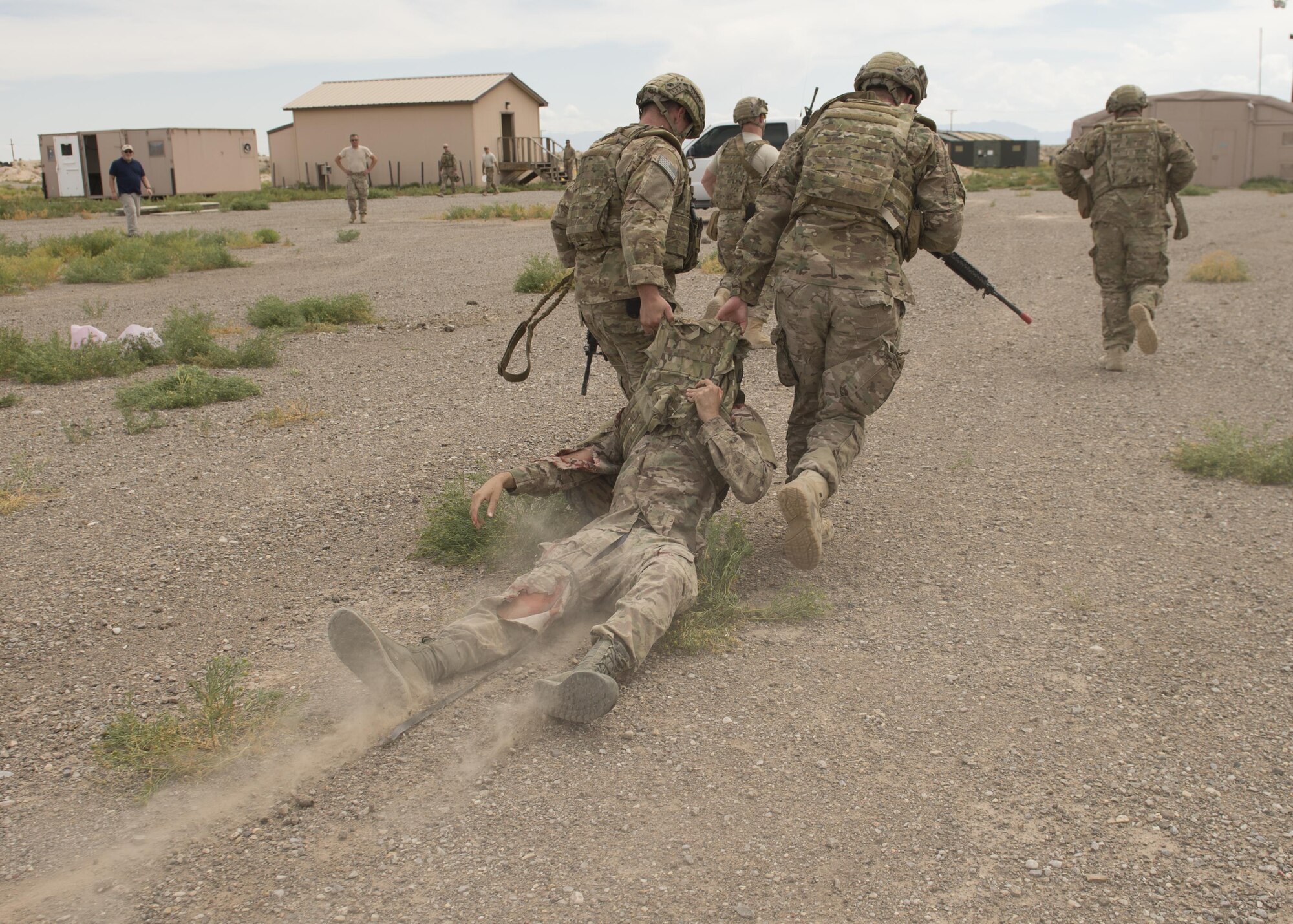 Explosive Ordnance Disposal Airmen extract a simulated casualty during a Tactical Combat Casualty Care exercise at Holloman Air Force Base, N.M., on April 31, 2017. The training focuses on individual trauma, tools, techniques, and treatment procedures. The exercise also included the use of moulage, non-lethal training munitions, trained role-players, and a multitude of other artificial stressors. (U.S. Air Force Photo by Senior Airman Chase Cannon)