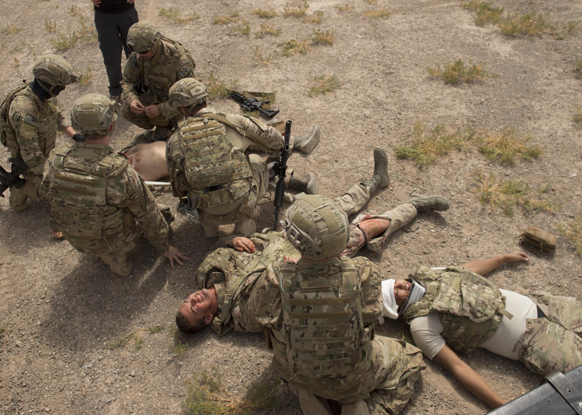 Explosive Ordnance Disposal Airmen practice Tactical Combat Casualty Care techniques on a simulated casualty during an exercise at Holloman Air Force Base, N.M., on April 31, 2017. The training focuses on individual trauma, tools, techniques, and treatment procedures. The exercise also included the use of moulage, non-lethal training munitions, trained role-players, and a multitude of other artificial stressors. (U.S. Air Force Photo by Senior Airman Chase Cannon)