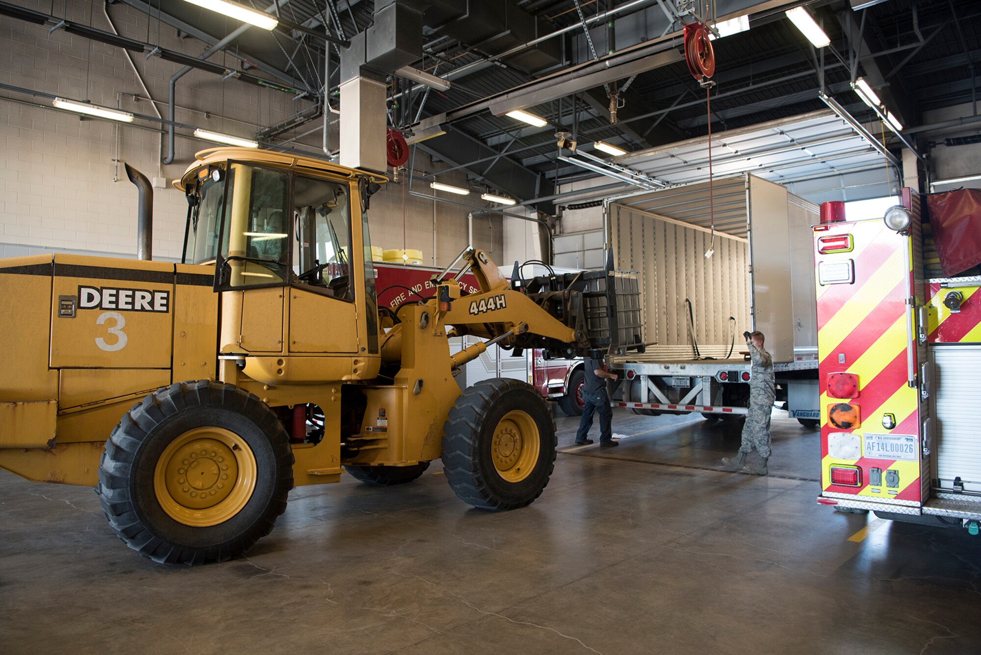 A 21st Civil Engineer Squadron Airman uses a front-end loader to load a container filled with aqueous film forming foam effluence into the back of a truck at Fire Station 1 at Peterson Air Force Base, Colo., April 19, 2017 so it can be transported to an off base contractor for disposal. The legacy AFFF from aircraft rescue firefighting vehicles was replaced with a newer formulated product containing significantly fewer perfluorooctanioc and perfluorooctanesulfonic acids , which are suspected of contaminating groundwater supplies in communities around the world where legacy AFFF was used. (U.S. Air Force photo by Steve Kotecki)