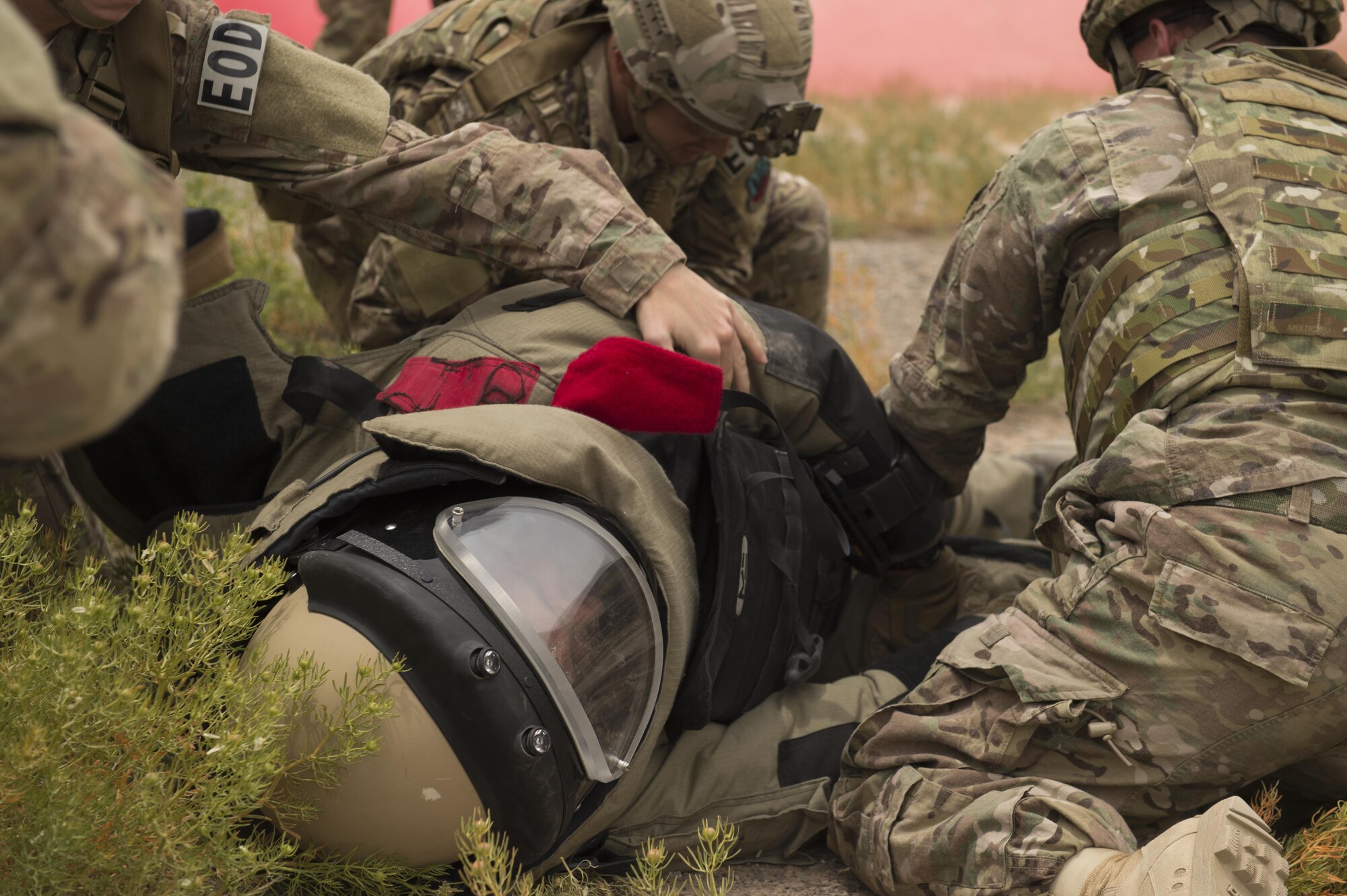 Explosive Ordnance Disposal Airmen assess a simulated casualty during a Tactical Combat Casualty Care exercise at Holloman Air Force Base, N.M., on April 31, 2017. The training focuses on individual trauma, tools, techniques, and treatment procedures. The exercise also included the use of moulage, non-lethal training munitions, trained role-players, and a multitude of other artificial stressors. (U.S. Air Force Photo by Senior Airman Chase Cannon)