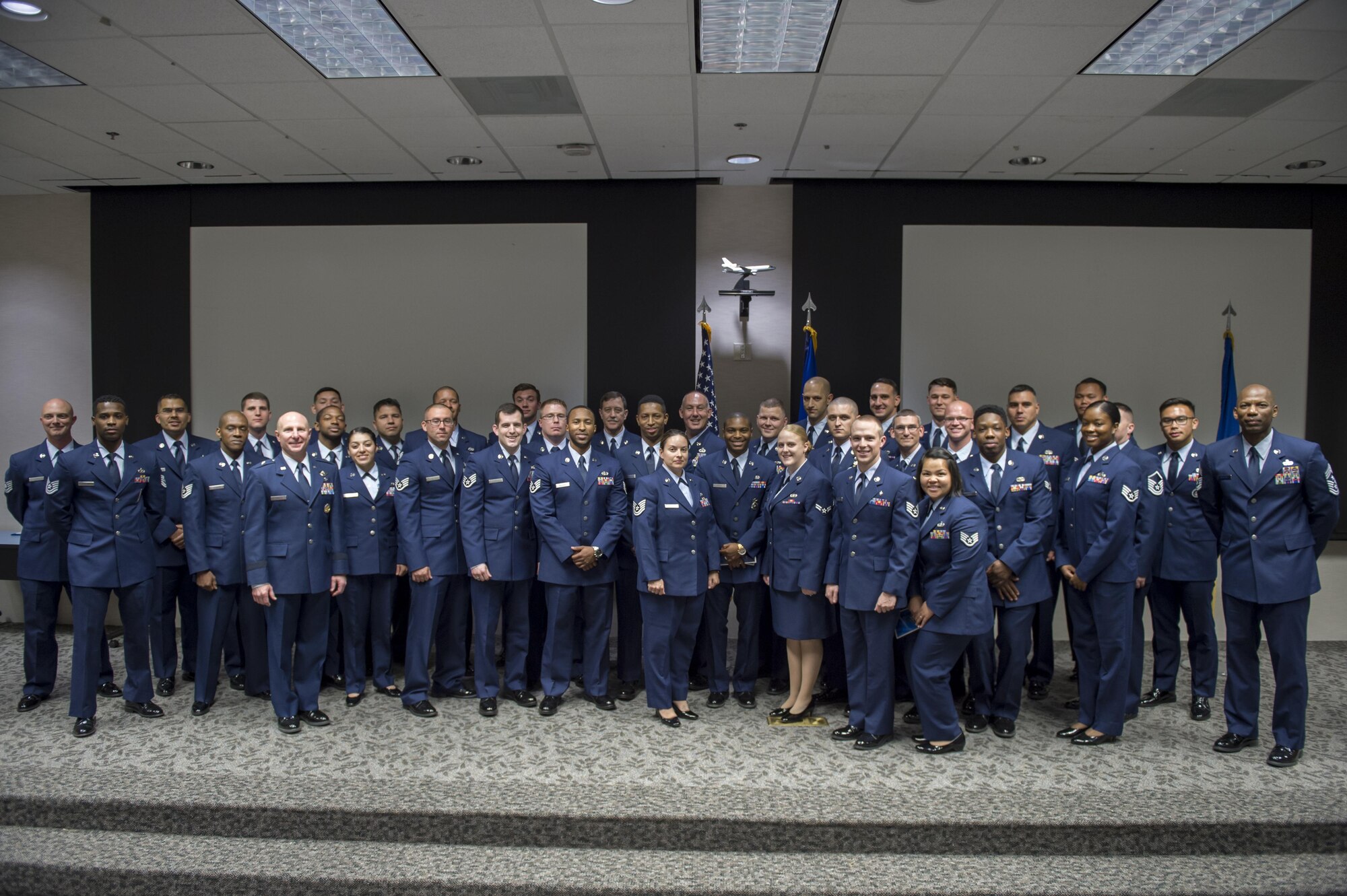 Community College of the Air Force and higher education graduates pose for a photo following their graduation ceremony May 23 at Airman and Family Readiness. (U.S. Air Force photo by Kyle Larson)