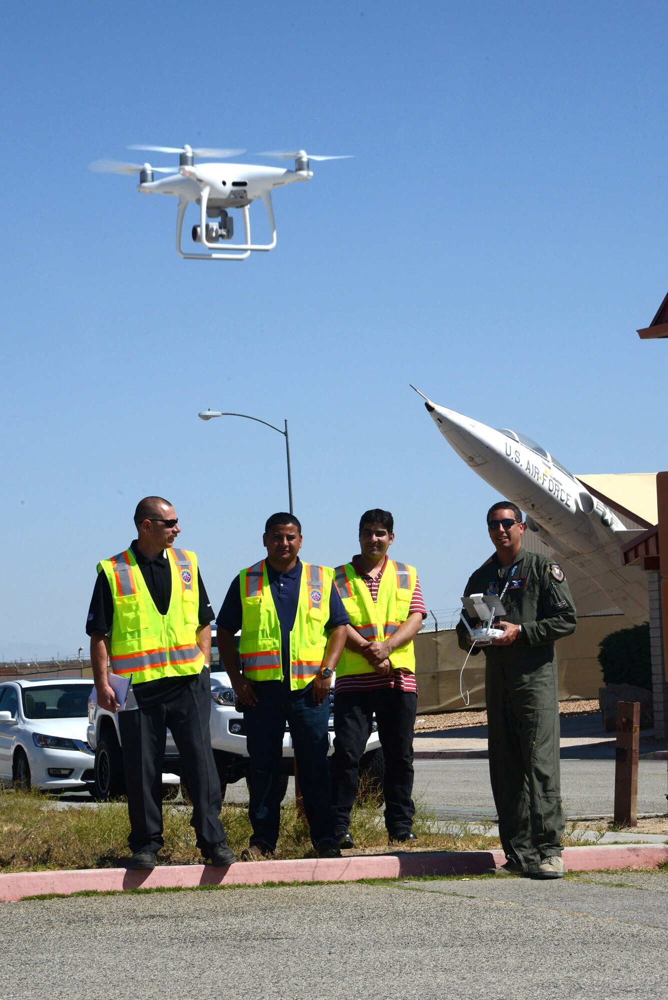 Maj. Danny Riley, director of the Emerging Technologies Combined Test Force, launches a small unmanned aerial system as members of the 412th Civil Engineer Group look on. The flight was done to evaluate its systems and to test its feasibility as a tool for the 412th Civil Engineer Group to perform roof inspections. (U.S. Air Force photo by Christopher Ball)