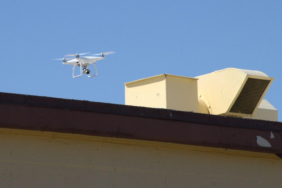 A small unmanned aerial system performs a roof inspection on Building 1401 near the Edwards flightline as part of a series of tests to determine its feasibility as an inspection tool for the 412th Civil Engineer Group. The tests were also flown to evaluate the performance of the aircraft’s systems. (U.S. Air Force photo by Christopher Ball)