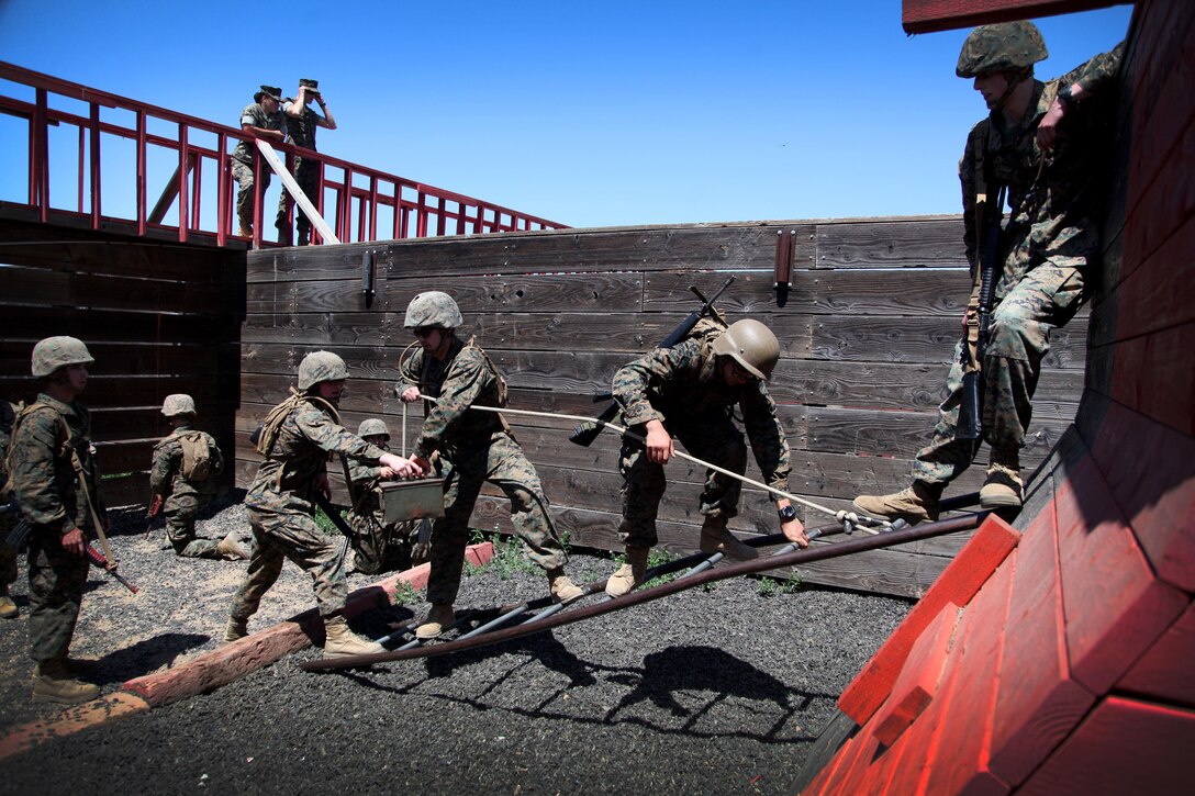 Officer Candidates navigate an obstacle during the leadership reaction course. 