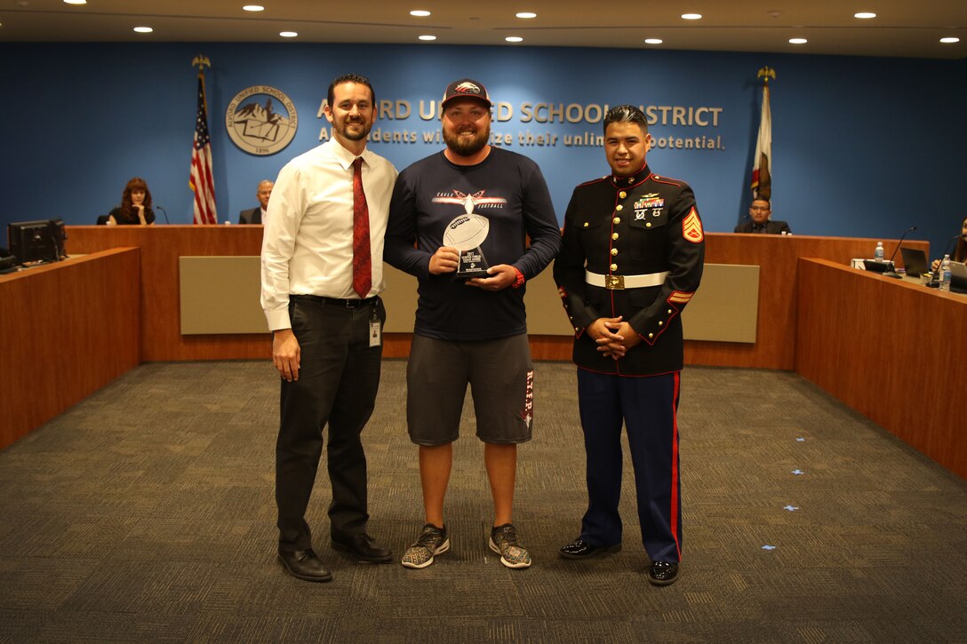 SSgt Castro presents the Semper Fi Coach of the year award to Garry Hedlund from La Sierra High School in Riverside, CA